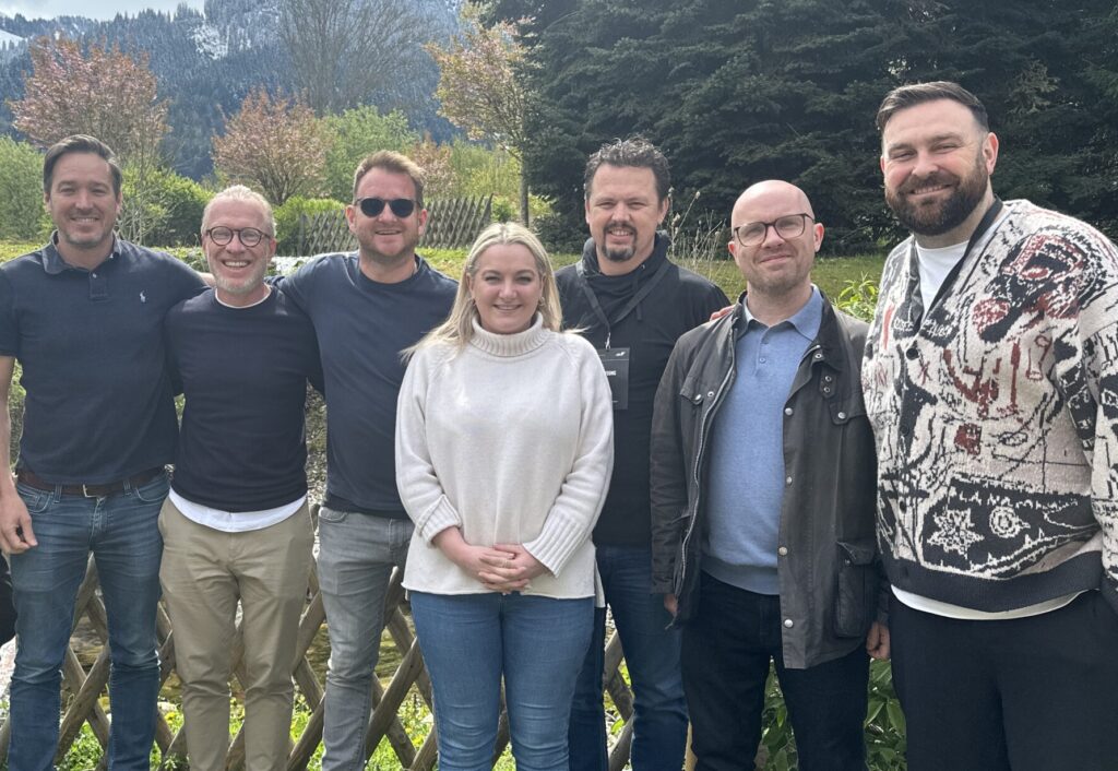 The Senior Leadership Team at Azarc pose in front of the Austrian mountains as they attend The Fast Track Way x YPO weekend.
