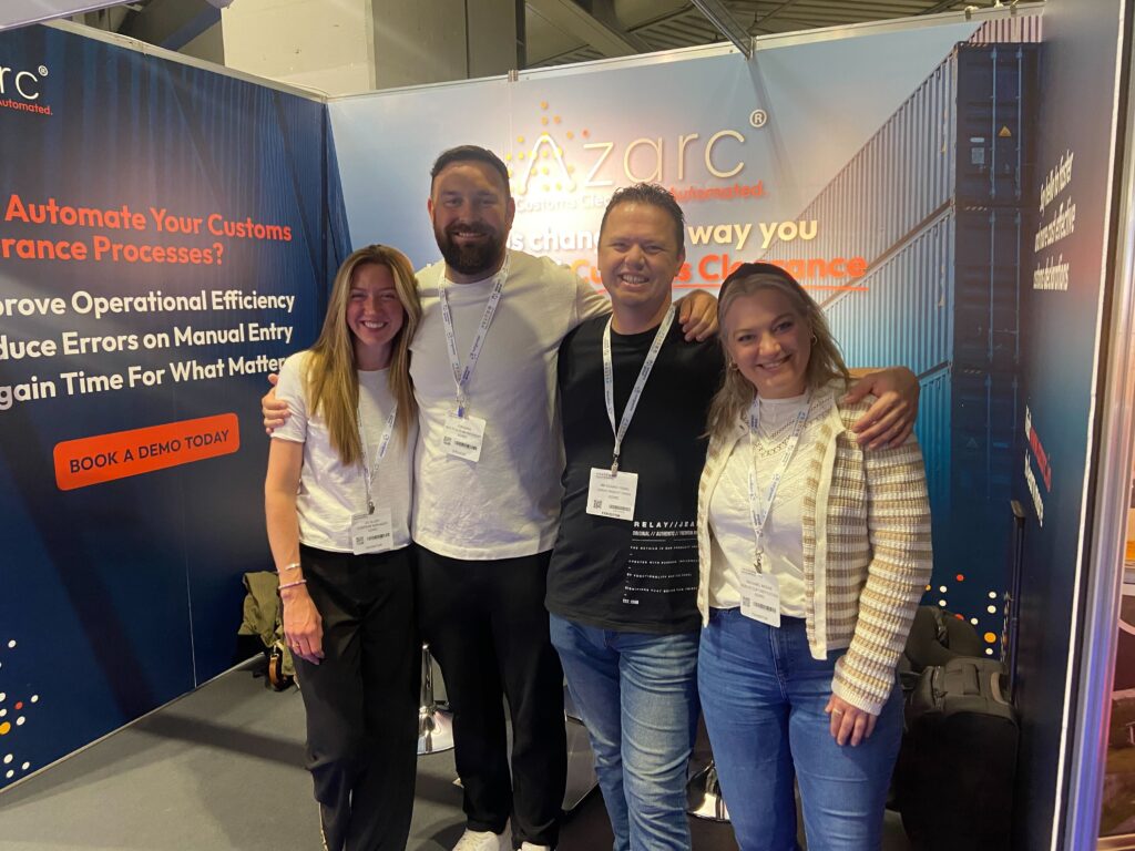 Jo Allen, Jon Bass, Richard Young and Rachael Moore standing in front of the Azarc booth at Multimodal 2024, NEC Birmingham