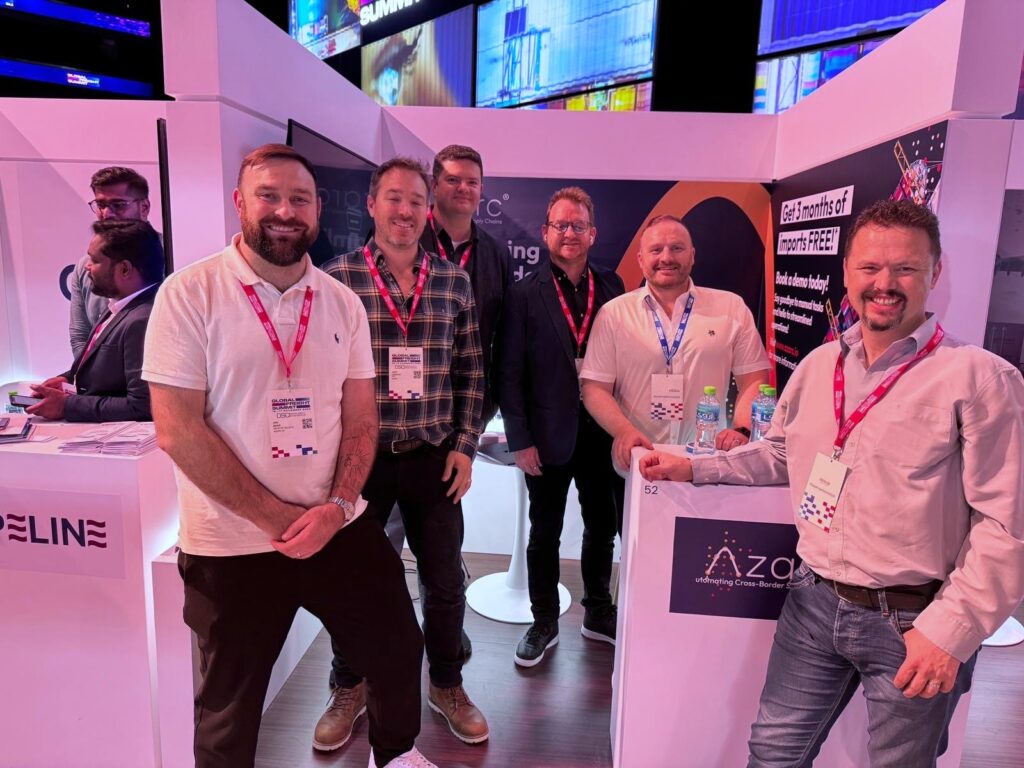 The Azarc team on their stand at the 2024 Global Freight Summit, smiling at the camera.