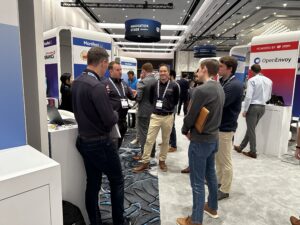A group of businessmen around Azarc's stand, on the Innovation stage in 2022, at Manifest 2022 in Las Vegas.